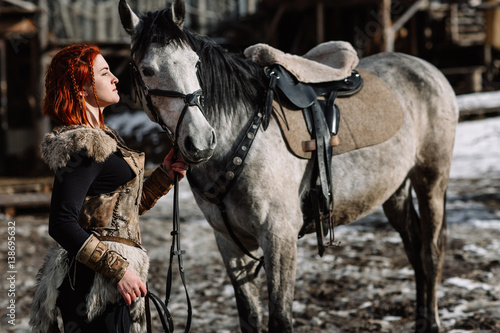 portrait of a girl with red hair in a Viking outfit