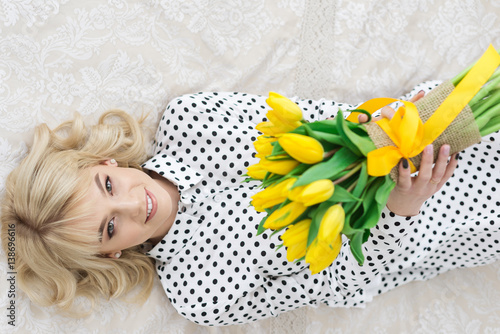 Happy woman with yellow tulips #138696616