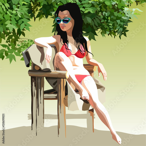 woman in a swimsuit sunbathing in a chair in the nature