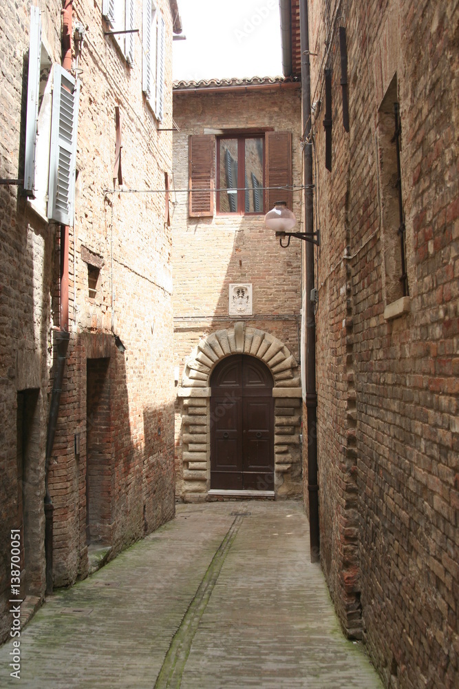 Small road in Urbino old downtown, central Italy