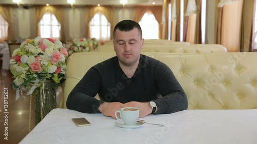 Man sitting on sofa and talking during a serious, emotional interview photo