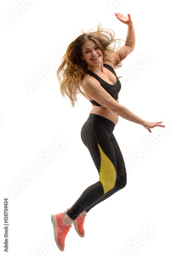 Young fitness woman jumping isolated on white
