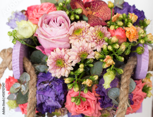 Bouquet of flowers in wooden box 