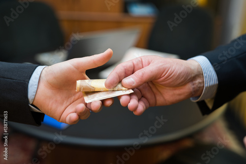 Man taking a bribe from another one photo