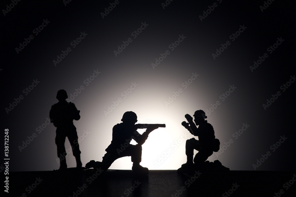 Silhouette of soldiers on a dark background Silhouette of soldiers on a dark background