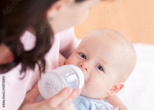 Mother feeding her baby boy...