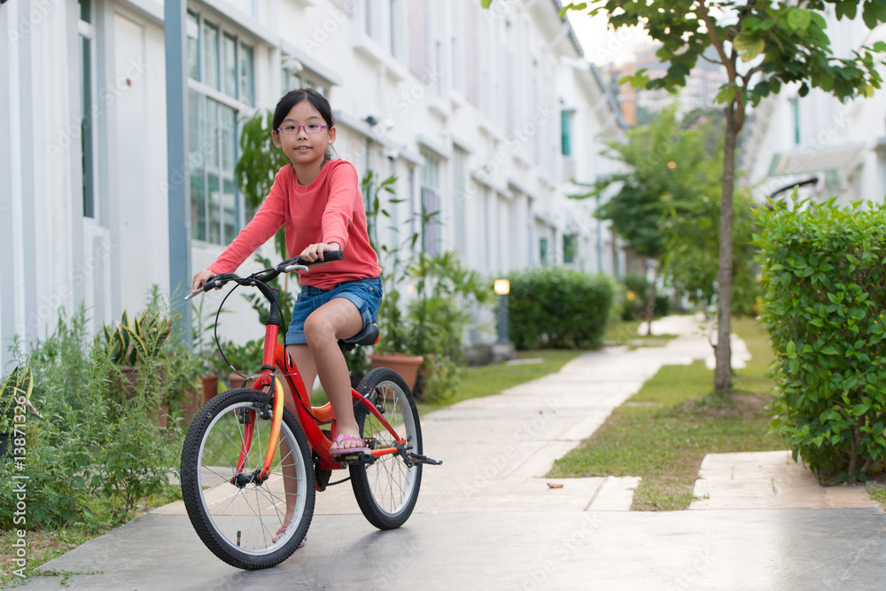 Fototapeta premium Little girl on bicycle