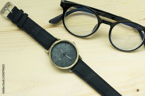 Fashion watches and glasses on the table.