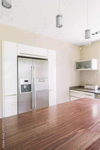 Spacious kitchen with wooden table top