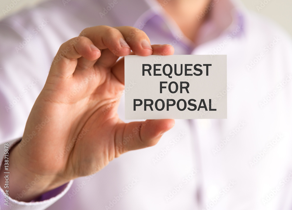 Businessman holding a card with XXXXXXXX message Businessman holding a card with XXXXXXXX message