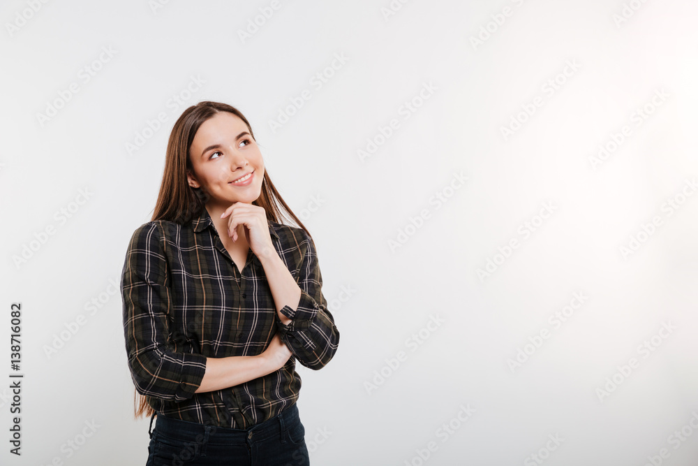 Smiling pensive Woman in shirt looking up Smiling pensive Woman in shirt looking up