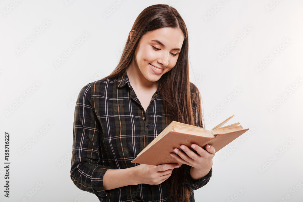 Smiling Woman in shirt reading book Smiling Woman in shirt reading book