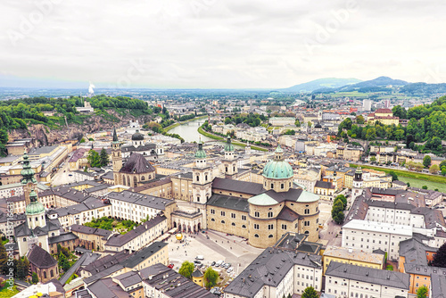 Panoramic view over stadt salzburg with salzach river, rainy day, fog and mountains, austria
