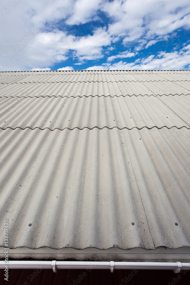 Asbestos slate roof against blue sky
