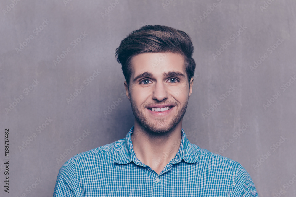 Obraz premium A portrait of handsome man in blue shirt looking at camera