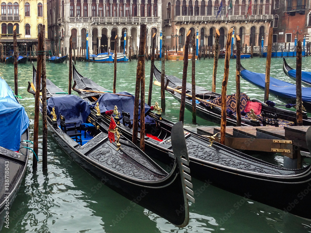 Gondolas sit docked.waiting for people board for travel on the grand canal in Venice, Italy