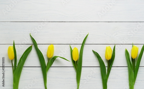 pattern of yellow tulips on a white wooden background