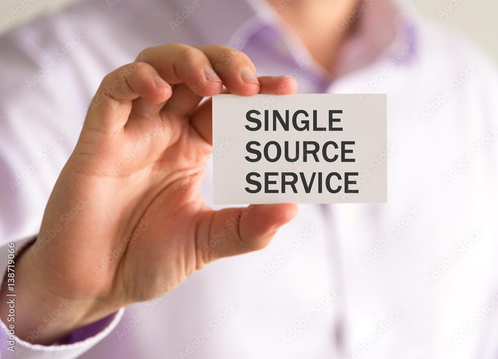 Businessman holding a card with SINGLE SOURCE SERVICE message Businessman holding a card with SINGLE SOURCE SERVICE message