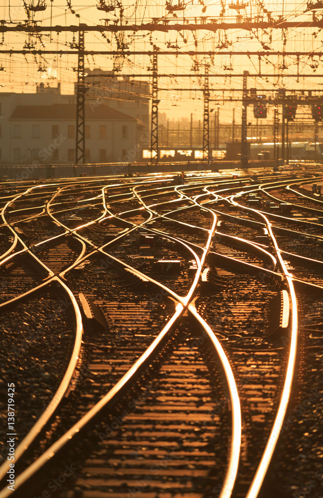Sunrise over empty railroad tracks at Perrache station in Lyon, France. Shallow D.O.F.