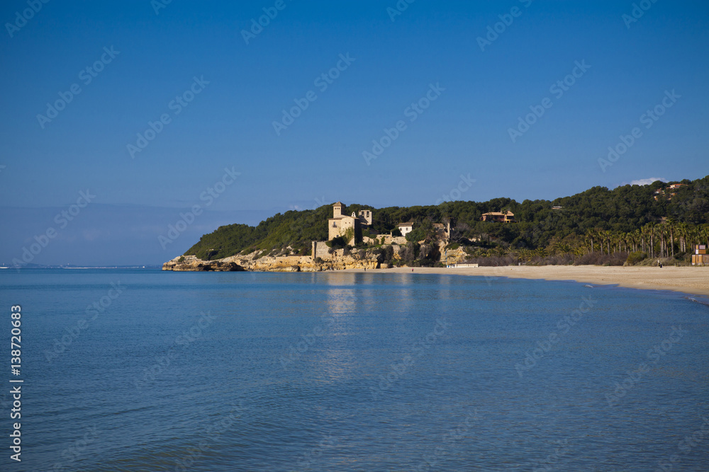 desert beach with a castle background in Tamarit, Altafulla, Tarragona, Catalonia, Spain