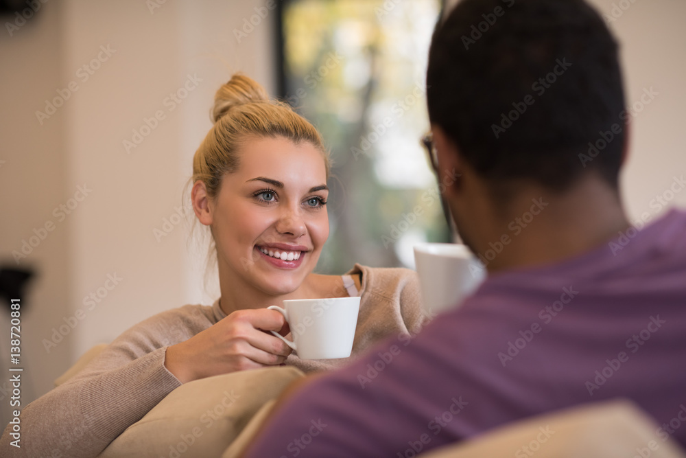 Young multiethnic couple in front of fireplace Young multiethnic couple in front of fireplace