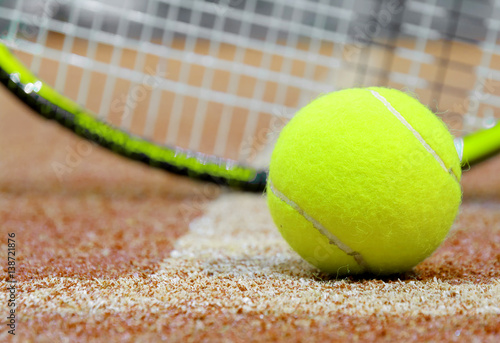 Tennis ball and racket on the court background