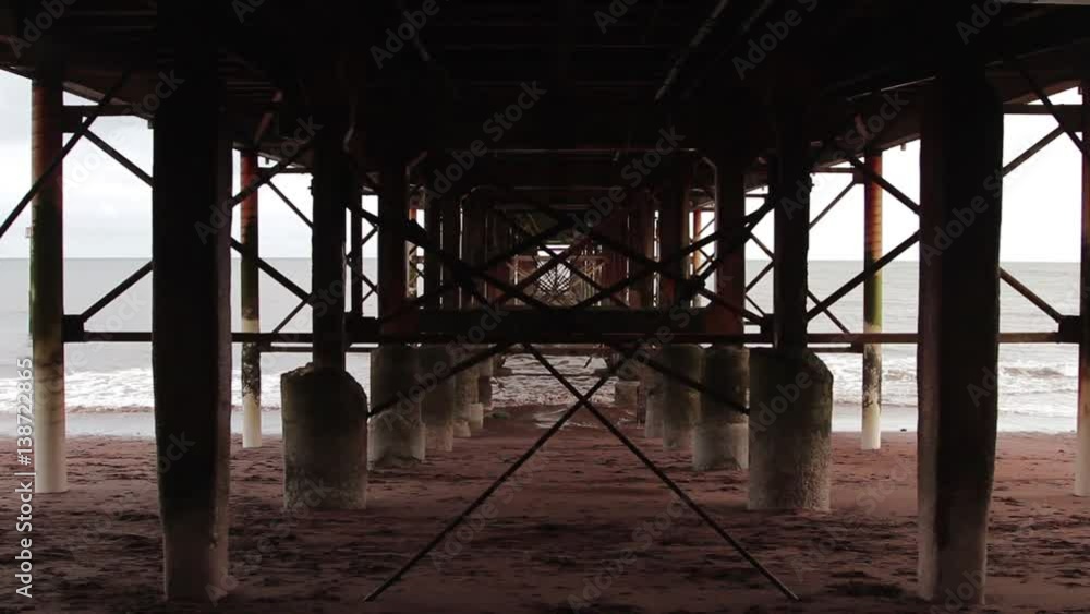 Seaside Pier Detail - Abstract Grunge Through Rusty Pillar Supports of Pier Metal Structure Seaside Pier Detail - Abstract Grunge Through Rusty Pillar Supports of Pier Metal Structure