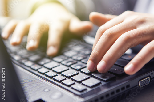 Technology, typing on a laptop keyboard (glare, flare)