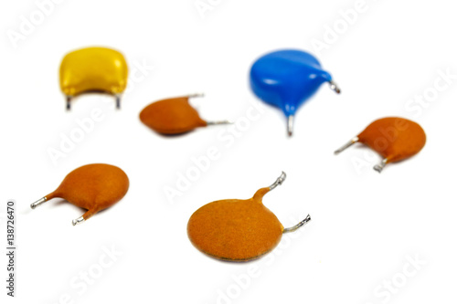 Set of capacitors in colored cases on a white background