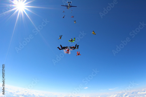Skydivers are training in the blue sky