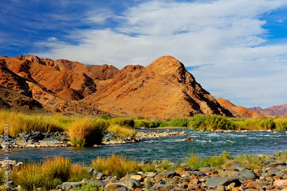 Reddish Mountains River and Blue Sky