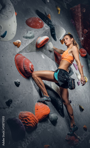 Female on indoor climbing wall.