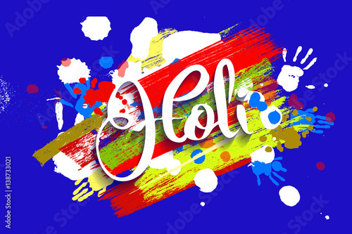 Happy holi on a background of hand prints.