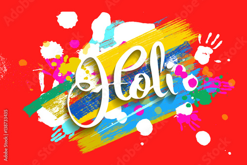 Happy holi on a background of hand prints.