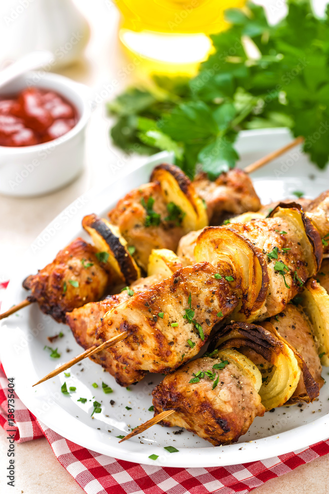 Grilled shish kebab or shashlik on skewers closeup on white background Grilled shish kebab or shashlik on skewers closeup on white background