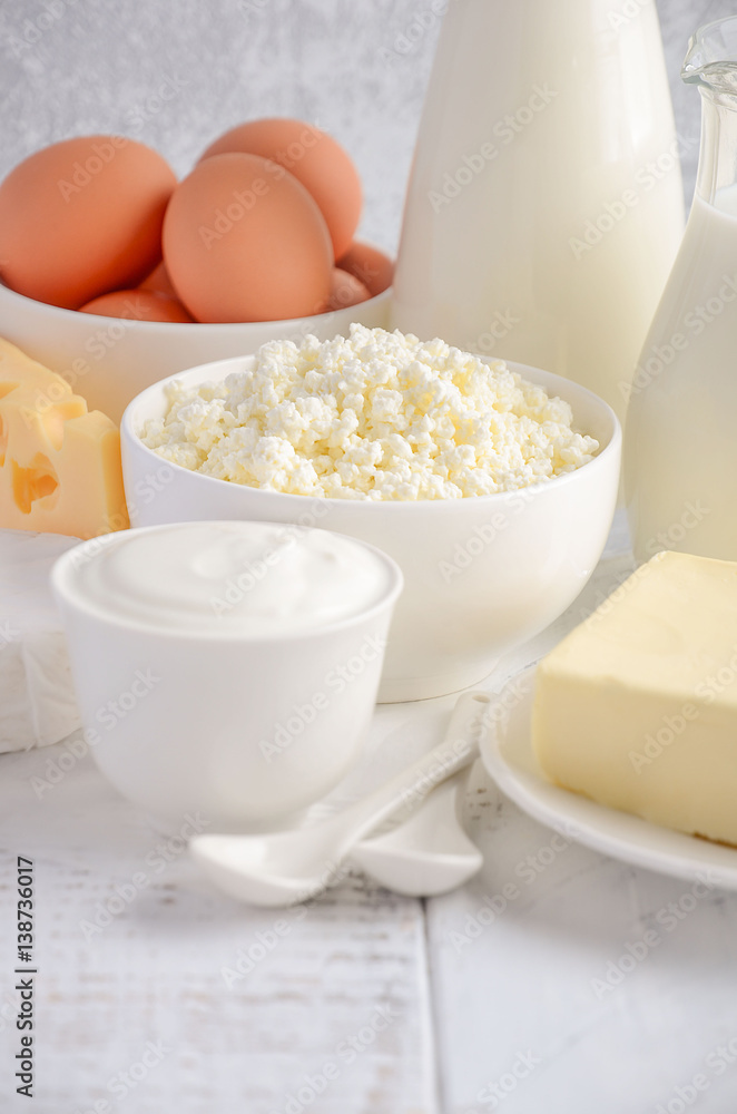 Fresh dairy products. Milk, cheese, brie, Camembert, butter, yogurt, cottage cheese and eggs on wooden table. Fresh dairy products. Milk, cheese, brie, Camembert, butter, yogurt, cottage cheese and eggs on wooden table.