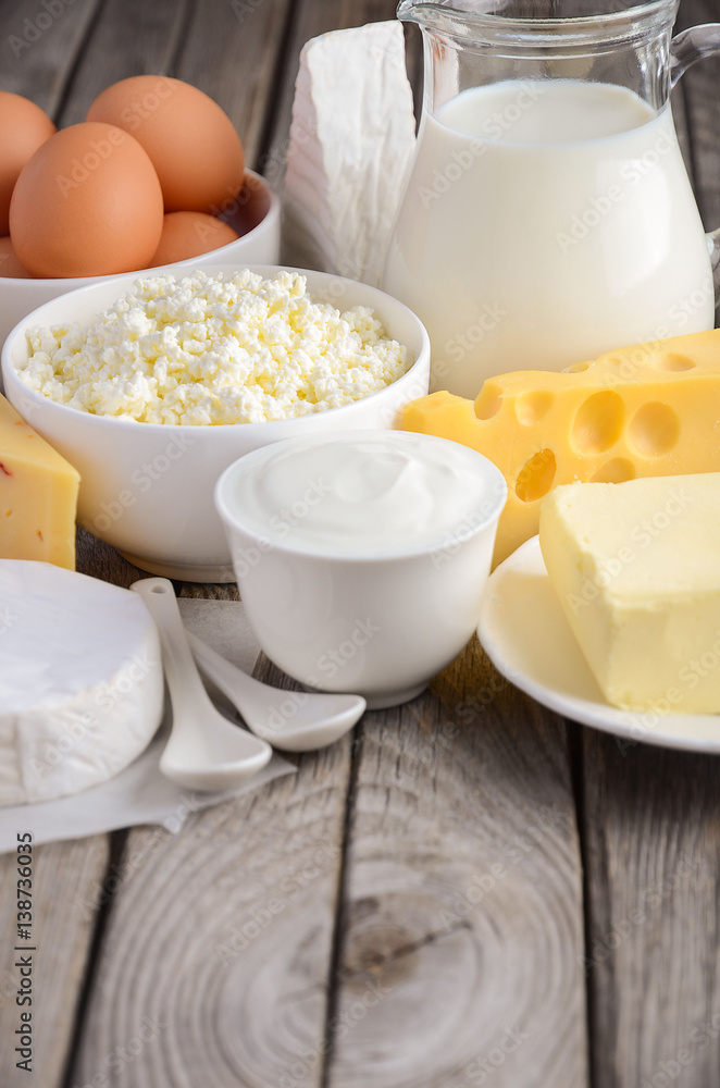 Fresh dairy products. Milk, cheese, brie, Camembert, butter, yogurt, cottage cheese and eggs on wooden table. Fresh dairy products. Milk, cheese, brie, Camembert, butter, yogurt, cottage cheese and eggs on wooden table.