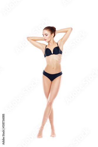 Fit, healthy and sporty woman in black underwear isolated on white. Sport, fitness, diet, weight loss and healthcare concept.