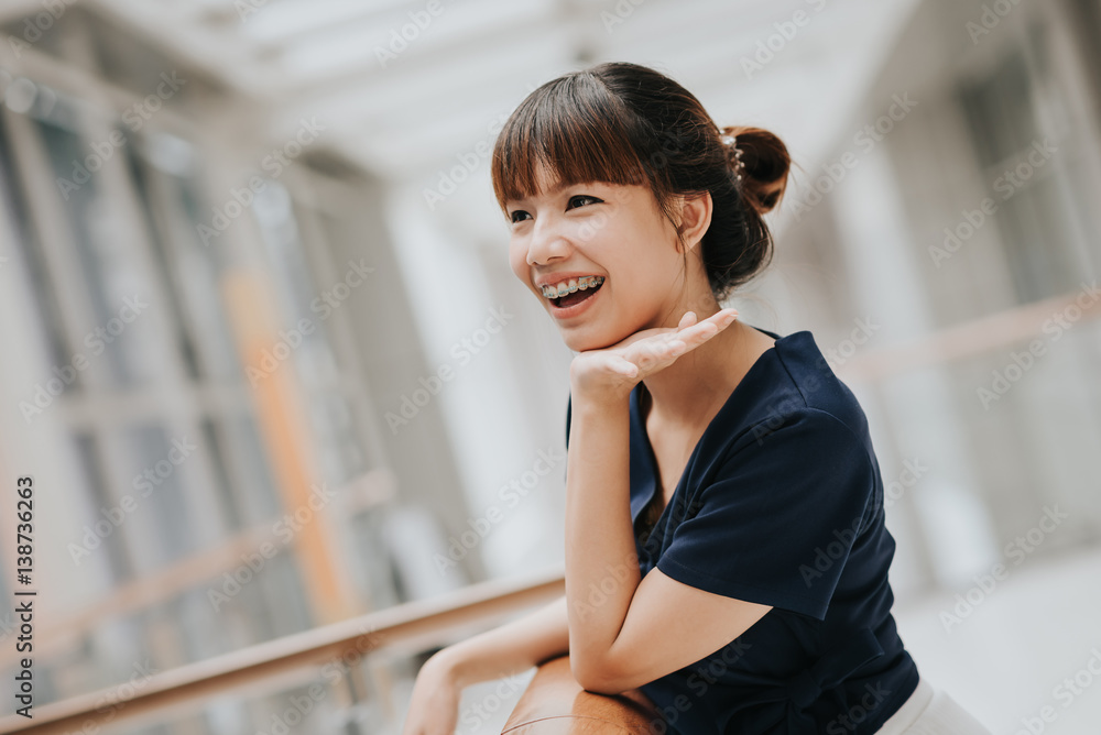 Portrait of happy young pretty Asian girl with braces smiling. Portrait of happy young pretty Asian girl with braces smiling.