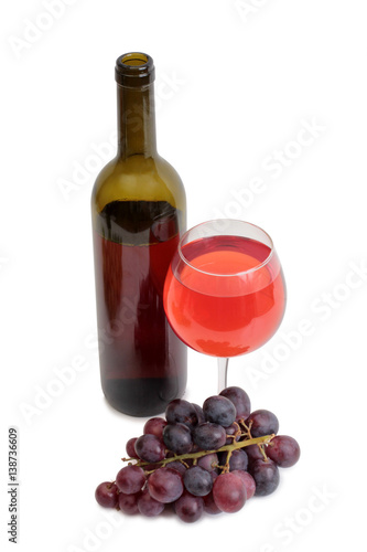Bottle glass of wine and grapes on white background