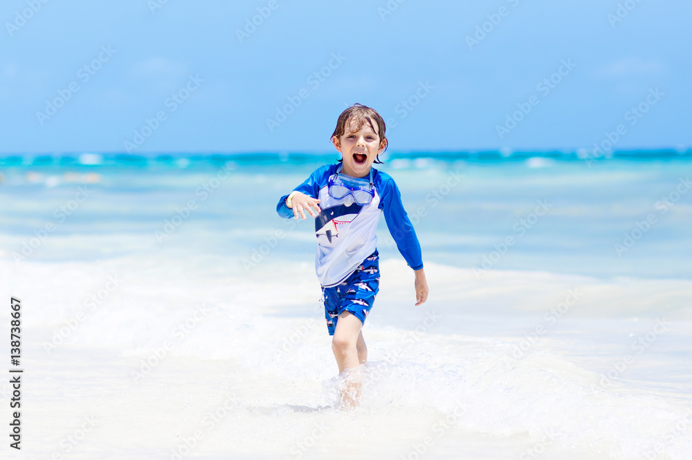 little blond kid boy having fun on tropical beach of Maldives little blond kid boy having fun on tropical beach of Maldives