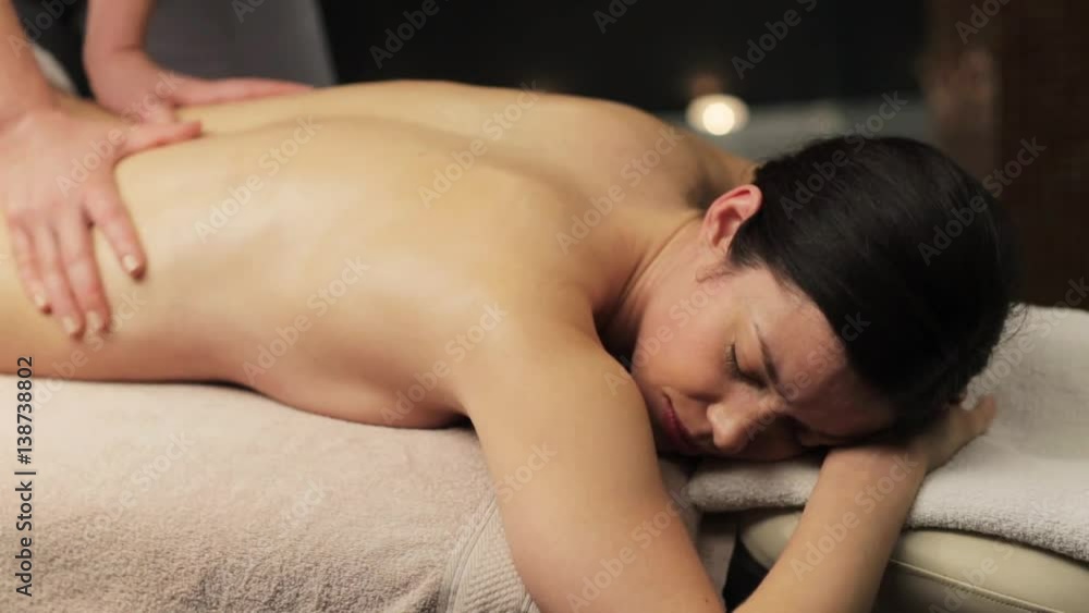 woman lying and having back massage at spa woman lying and having back massage at spa