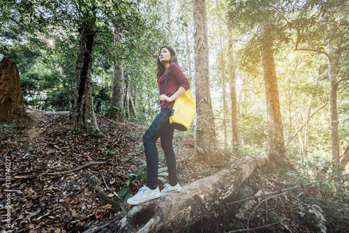 Happy young asian women backpack in the forest