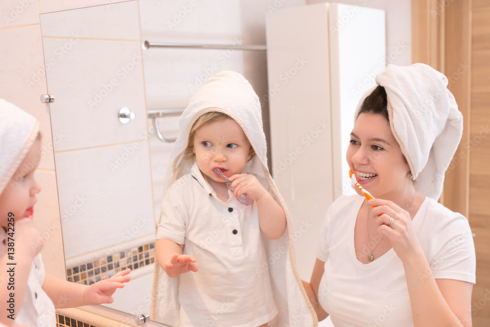 Mother and child little boy cleans teeth Mother and child little boy cleans teeth