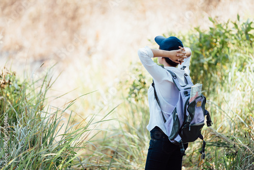 Hipster young girl with backpack in forest © iStocker