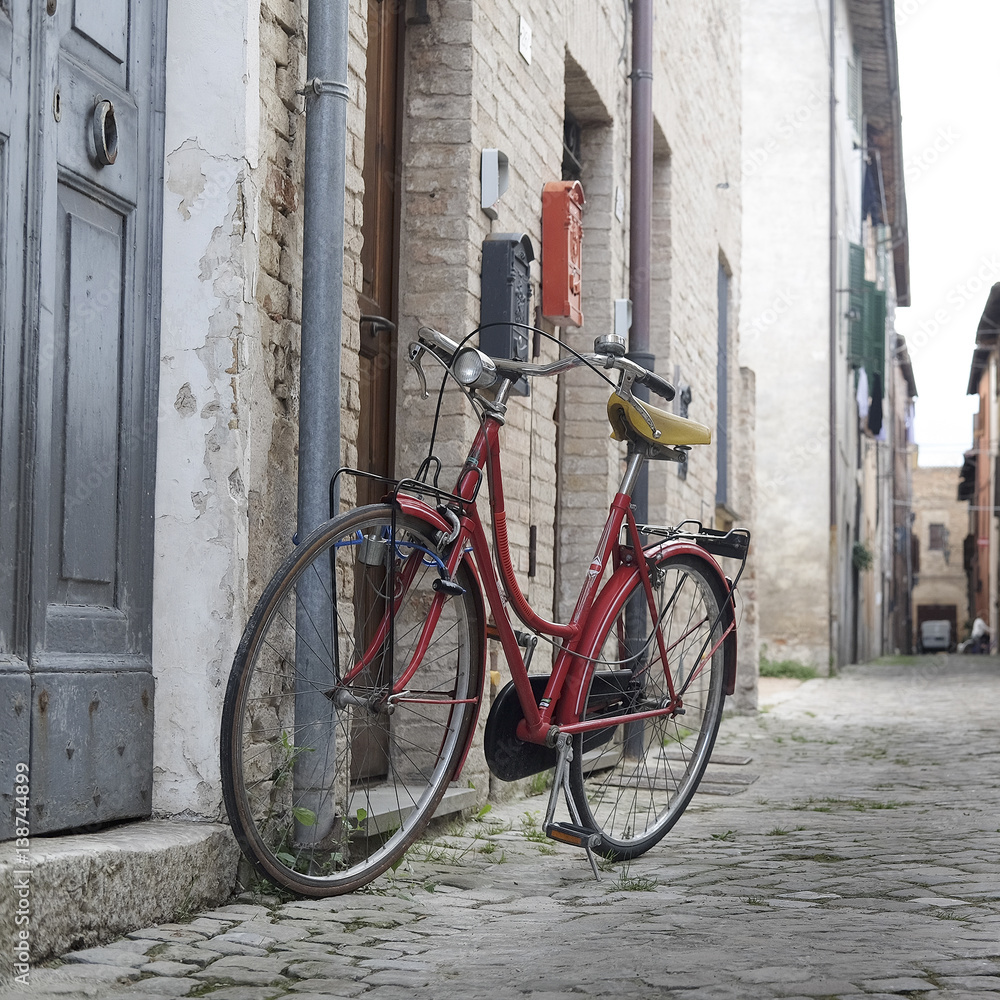 Urbania, Italy - August, 1, 2016: bicycle on a street in an ancient part of Urbania, Italy