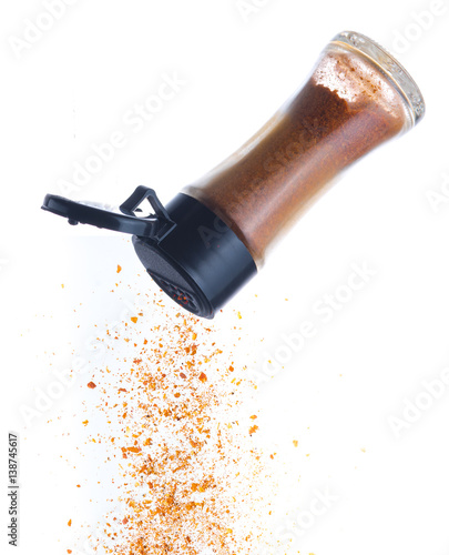 Cayenne pepper pour from Bottle on white,Flying Cayenne pepper photo