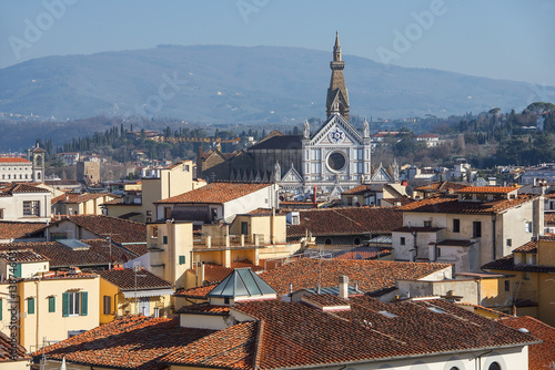 view of the Basilica di Santa Croce through the roofs of the old Florence, Italy photo