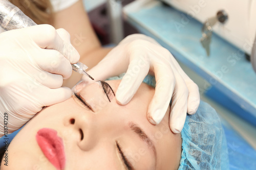 Cosmetologist applying perm...