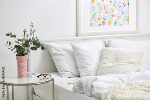 Konstfotografi Bedroom interior with bed and flowers on nightstand
